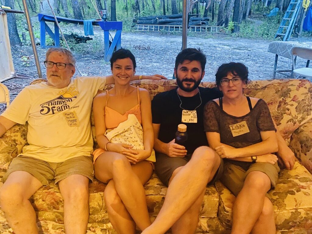 Marty, Bianca, Dave, and Ishka sitting on a couch at the Twin Oaks Conference